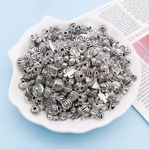 Close-up of antique silver alloy spacer beads with vintage butterfly and heart patterns