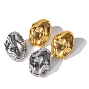 Minimalist hammered lava style stud earrings in gold and silver finish on white background