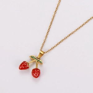 Sweet strawberry pendant necklace in gold finish with red enamel on white background