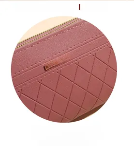 Close-up of quilted PU leather texture and golden metal logo on the long wallet