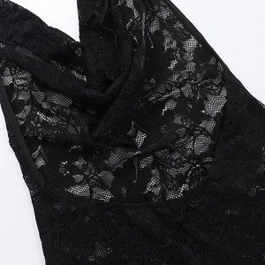 Close-up detail of delicate black crochet floral lace fabric with intricate mesh patterns