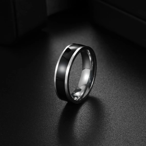Macro shot of silver and black striped titanium steel ring with smooth polished finish