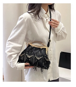 Detail of vintage evening clutch with tassels, sequins, and a metallic handle for women