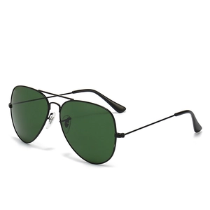 Classic aviator sunglasses with black metal frames and dark green teardrop lenses