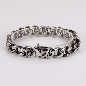 Close-up of vintage silver stainless steel chain bracelet with embossed leopard patterns
