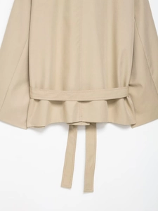 Macro detail of khaki twill jacket back featuring waist belt and stitching detail