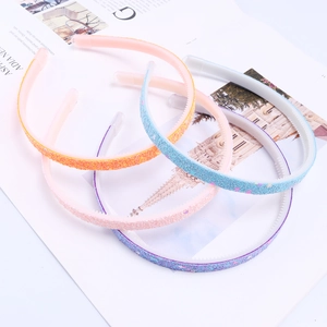 Detail of colorful glitter hairbands showing non-slip inner teeth and sparkling texture