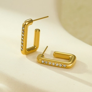 Detail shot of gold-plated U-shaped earrings with micro-inlaid white cubic zirconia