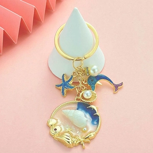 Blue ocean themed gold keychain with starfish, dolphin and shell pendants with pearls