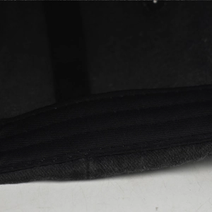 Close-up of the meticulous flat seam stitching and washed fabric texture of the baseball cap