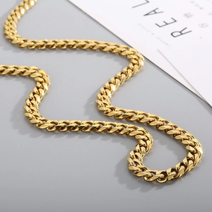 Detailed close-up of a gold-plated Cuban link chain with a glossy metallic finish
