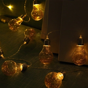 Vintage LED copper wire string lights with warm glowing decorative bulbs for Christmas