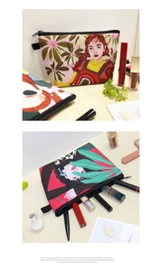 Macro view of printed canvas travel cosmetic bag with tropical illustration and side strap