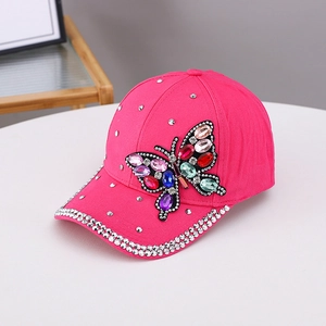 Rose pink baseball cap with vibrant rhinestone butterfly and sparkling brim accents