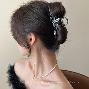 Elegant silver metal hair claw with flower, moon motifs and hanging pearl pendant adornment