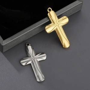 Polished gold and silver cross pendants with embossed patterns and hanging rings