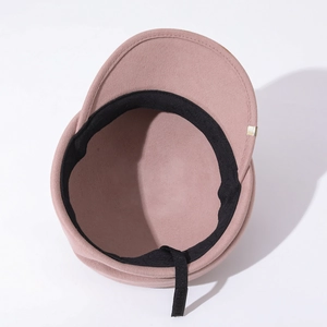 Detail view of pink wool newsboy hat featuring inner sweatband and adjustable drawstring