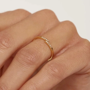 Macro shot of gold bypass ring with two rows of fine pavé diamonds on finger