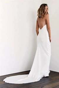Elegant backless white satin evening gown featuring a deep V-back and a long fishtail train