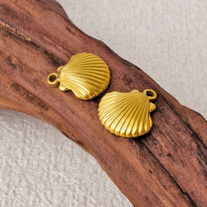 Golden 304 stainless steel shell pendants on rustic wood for jewelry making