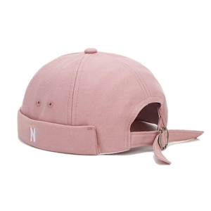 Pink canvas docker hat with white N embroidery and adjustable vintage metal strap buckle