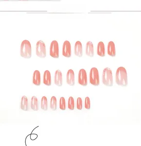 Macro detail of French pink gradient press-on nails with delicate white floral patterns