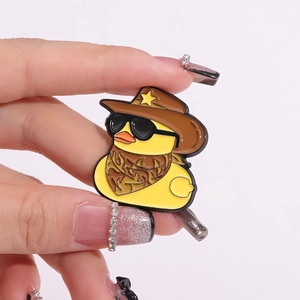 Broche en émail canard jaune avec chapeau de cowboy et lunettes de soleil sur fond gris