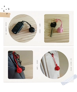 Detailed views of handmade braided monkey fist knot keychains on bags and keys