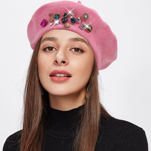 Detailed view of pink wool beret hat adorned with colorful rhinestones and jewels