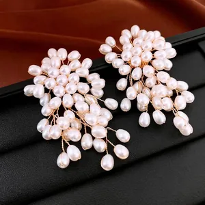 Floral cluster earrings with white teardrop pearls and golden wire handmade design