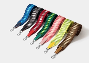 Detail of colorful woven wide shoulder straps with silver metal swivel hooks for bags