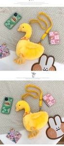 Detail of yellow plush duck crossbody bag featuring a plaid scarf and nylon strap