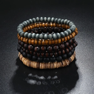 Macro detail of multi-layered elastic wooden bead bracelets in natural brown tones