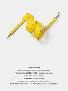 Close-up of yellow leather adjustable bag strap with premium gold metal lobster clasps