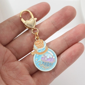 Creative gold heart keychain with jellyfish wish bottle enamel pendant held in hand