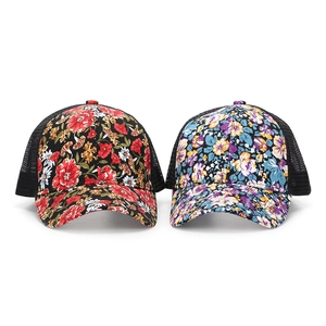 Detail of floral mesh baseball caps in black and light purple with breathable back mesh