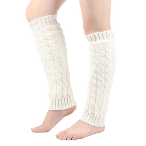 Detailed close-up of cream knit leg warmers featuring a classic cable pattern design