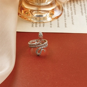 Detailed view of vintage silver snake ring with textured scales and wrap-around design