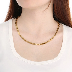 Close-up of a golden pig nose chain necklace on a model with a minimalist link design