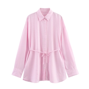 Pink linen long sleeve shirt for women with waist tie detail on a white background