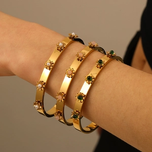 Three 18K gold-plated stainless steel daisy flower bangles with natural stone and pearl