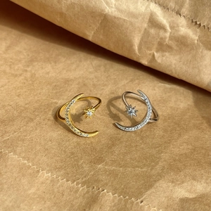 Detail of adjustable star and moon rings with sparkling zircon inlay in gold and silver finish