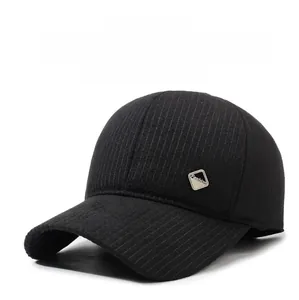 Detailed view of winter warm baseball cap featuring ear protection and metal fashion logo