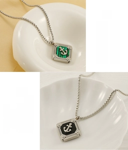 Detail of stainless steel anchor pendant with malachite and black inlay textures