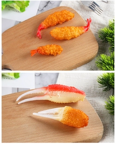 Realistic fried tempura shrimp and crab claw models on a rustic wooden board for display