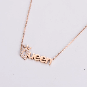 Close-up of a rose gold Queen necklace pendant with clear cubic zirconia stones