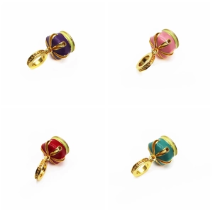 Detailed view of colorful enamel and gold beads in purple, pink, red, and cyan colors