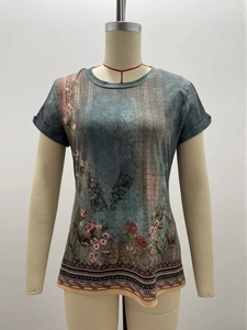 Detailed close-up of ethnic floral print and vintage patterns on women summer T-shirt