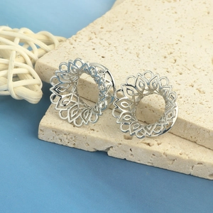 Silver mandala hollow flower ear gauge stretcher plug shown from a 45-degree angle