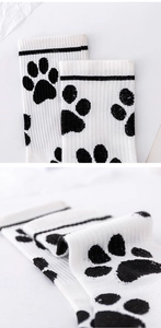 Detail of high-density knit cotton socks featuring a cute black cat paw print design